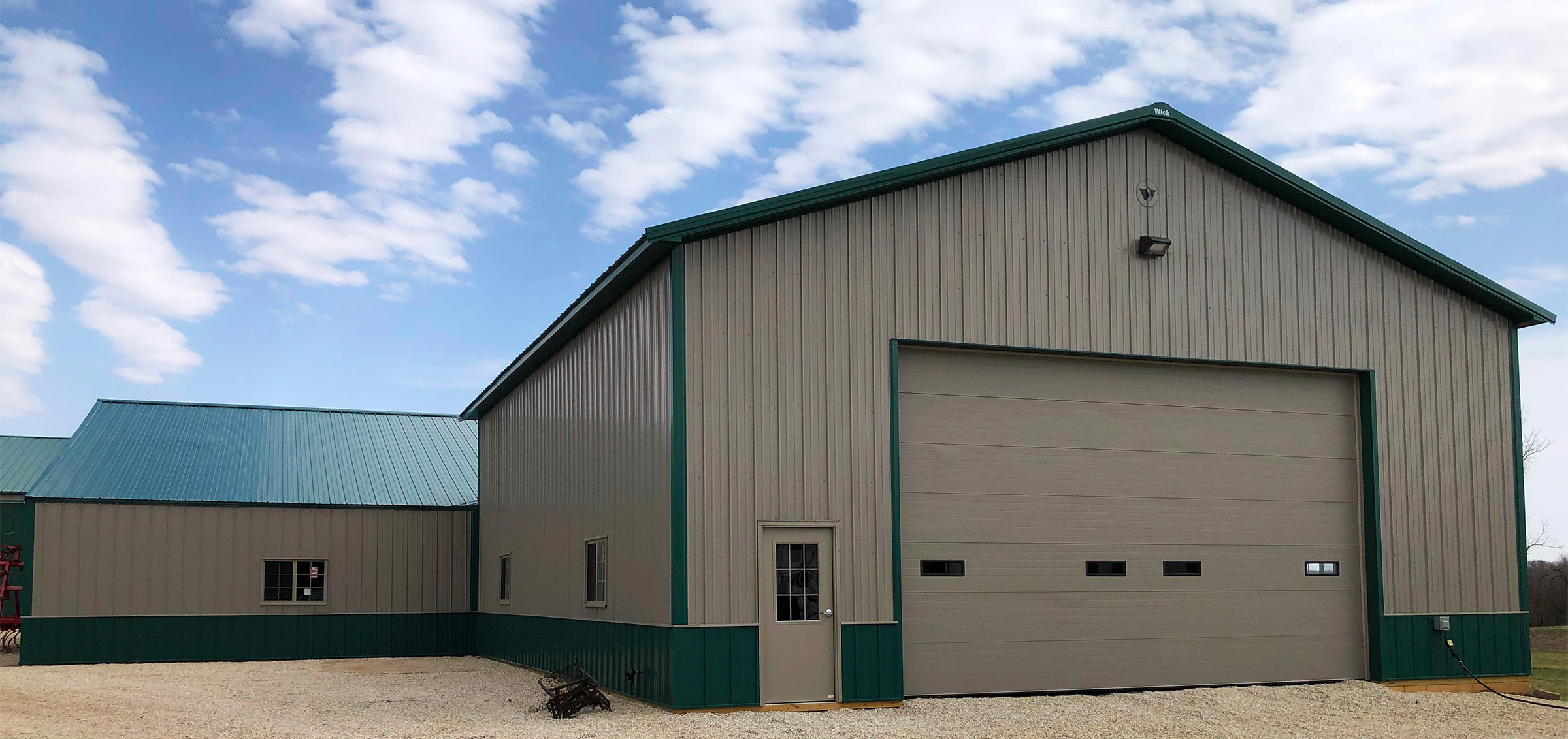 beige and green post frame agricultural building