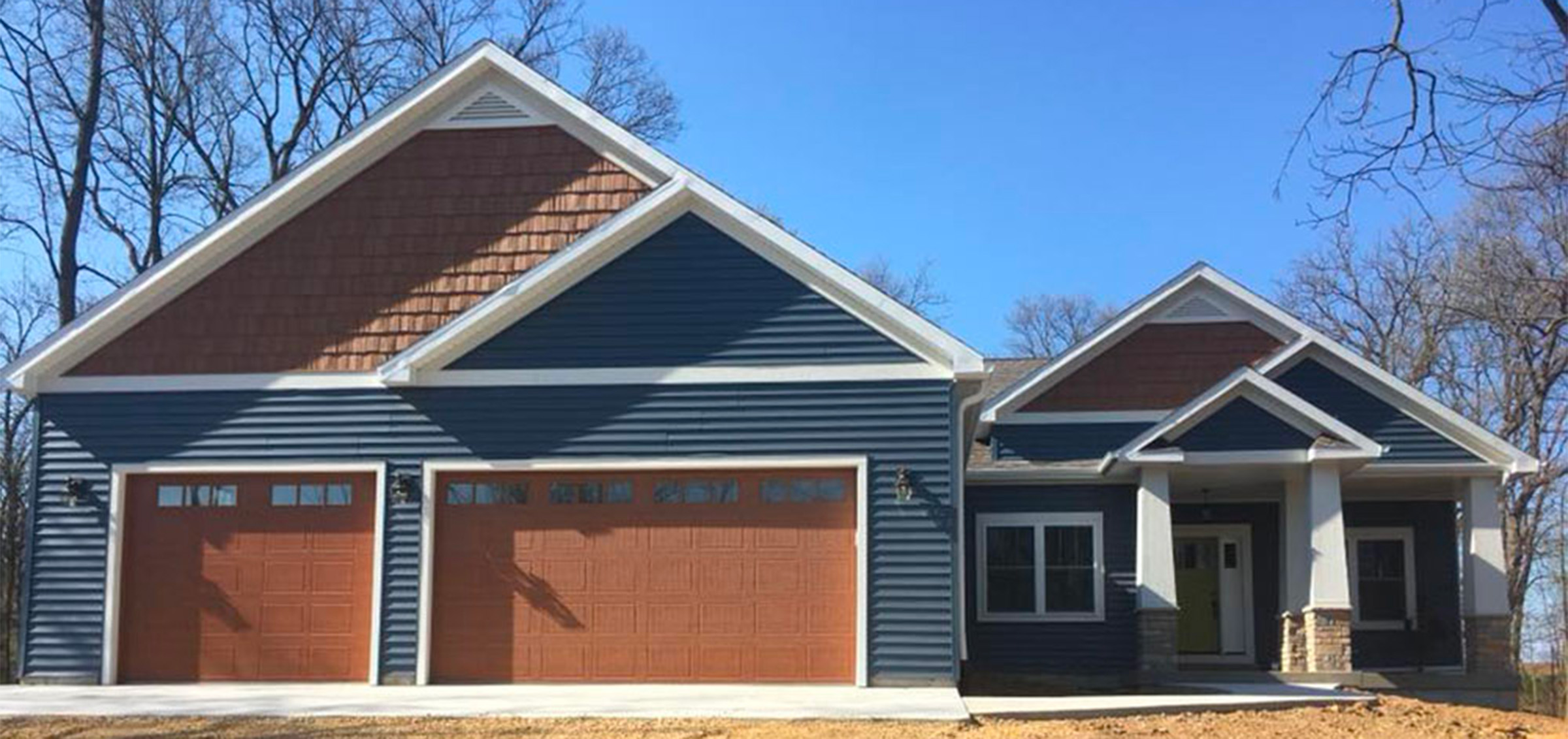 blue and brown post frame pole barn home